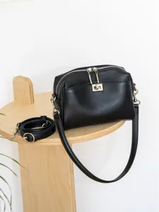 Black genuine leather shoulder bag for women, chic crossbody purse with turn lock and silver hardware.