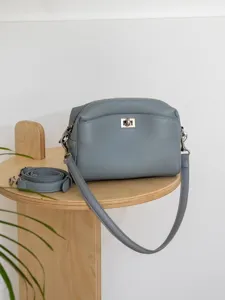 Grey leather shoulder bag with turn lock closure, stylish crossbody bag for women daily use.