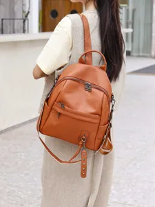Genuine leather backpack for women, stylish brown travel daypack with multiple zipper pockets.