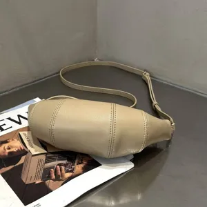 Detailed shot of the minimalist genuine leather crossbody dumpling bag with unique vertical seams.