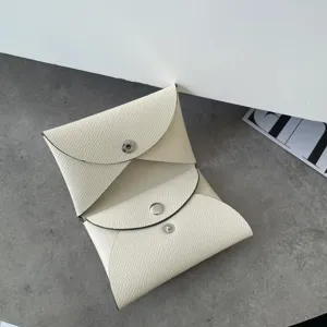 Genuine leather envelope card holder and coin purse, minimalist luxury detailed view.