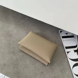 Minimalist genuine leather card holder, pebbled texture, sleek folded design, chic accessory.