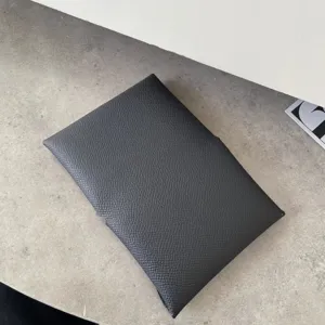 Detailed view of premium textured leather card holder, classic minimalist mini wallet design.
