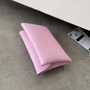 Pink genuine leather folding card holder, minimalist coin purse with classic textured finish.