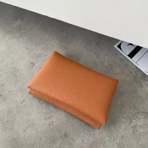 Detailed view of orange genuine leather card holder, classic palm pattern coin purse for daily use.