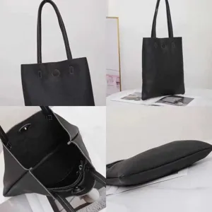 Detailed view of black genuine leather tote bag, large capacity shoulder bag showing texture.