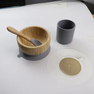 Bamboo baby bowl set with silicone suction base and matching cup for daily toddler feeding.