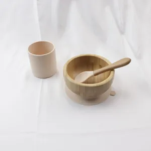 Baby bamboo bowl set with silicone suction cup, cup, and spoon for infant feeding.