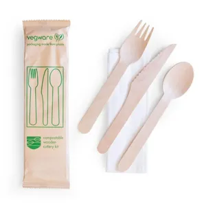Disposable wooden cutlery set detail showing fork, knife, spoon, napkin, and eco packaging.