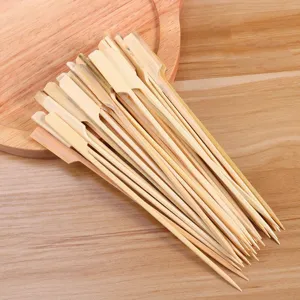 Bamboo skewers for BBQ, disposable wooden sticks with flat handle, detailed shot.