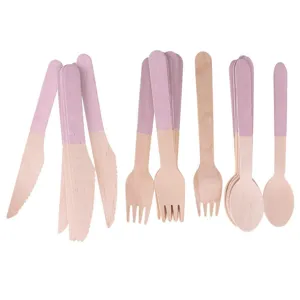Disposable birch wood cutlery set, pink dipped handle knife fork spoon for dessert and cake detail shot.