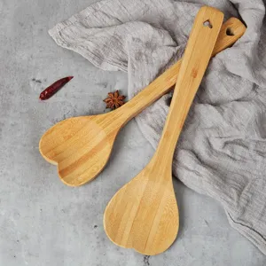 Natural bamboo heart-shaped kitchen spoon, eco-friendly wooden cooking spatula and salad stirrer.