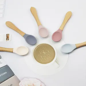 Cute silicone spoons with natural wooden handles set for kitchen dining and baby feeding.