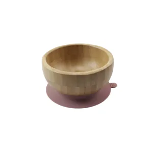 Wooden bamboo bowl with pink silicone suction base, eco-friendly tableware for daily kitchen use.