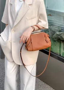 Genuine leather geometric shoulder handbag casual crossbody bag with top handle and strap.