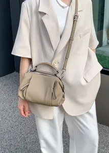 Casual genuine leather shoulder bag lifestyle detail view showcasing soft texture and versatile style.