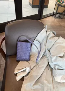 Purple woven leather mini crossbody bag detailed view, stylish chic small shoulder phone bag.