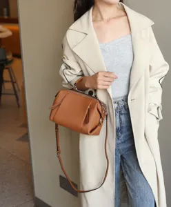 Detail shot of a brown genuine leather handbag, casual crossbody and shoulder bag.