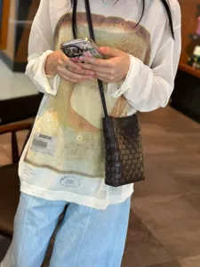 Detail view of the stylish woven leather phone crossbody bag, featuring a unique textured design.