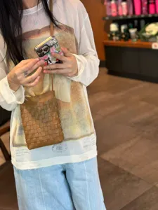 Brown woven leather phone bag, minimalist crossbody bag for women, stylish daily accessory.