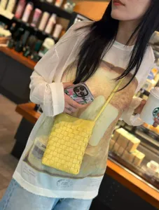 Yellow woven leather crossbody phone bag, stylish compact shoulder bag for women daily use.