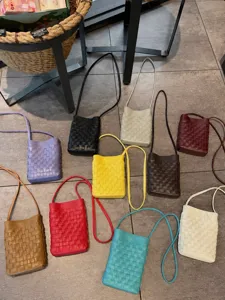 Woven leather crossbody phone bag with slim strap, stylish mini shoulder bag for women.