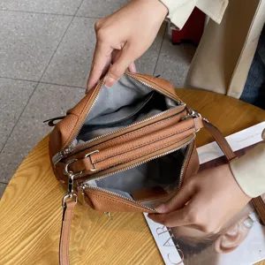 Genuine leather crossbody shoulder bag for women, stylish brown casual handbag with multi-pockets.