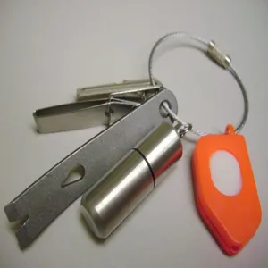 Multifunctional stainless steel wire rope keychain set with mini pry bar and capsule tool.