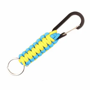 Closeup of blue and yellow paracord keychain with black carabiner and metal ring detail.