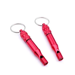 Red metal emergency survival whistle with key ring for outdoor travel and camping safety.
