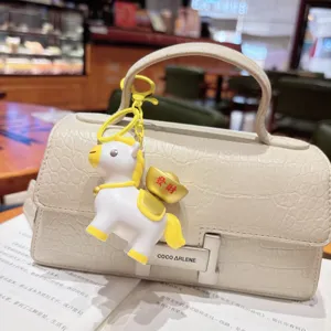 Cute rotating horse keychain and bag charm with lucky ingots, creative zodiac accessory.