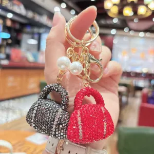 Detail view of luxury rhinestone handbag keychain with pearls and sparkling crystals for keys.