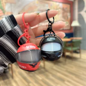 Mini motorcycle helmet keychain with LED light, creative car accessory and bag pendant.