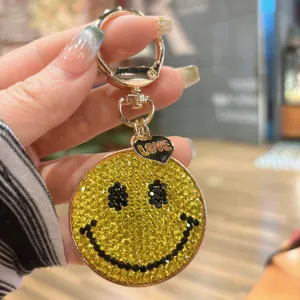 Alloy rhinestone smiley face keychain bag charm detail close up sparkling yellow crystal.