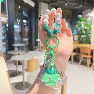 Beaded quicksand Christmas tree keychain, acrylic cute bag charm and car key accessory detail.
