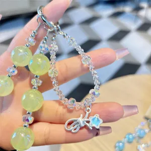 Detailed shot of the crystal beaded strap, featuring glowing green beads and cute star pendant.