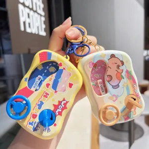 Miniature cartoon water game keychain toy detail view, cute steering wheel design and bright colors.