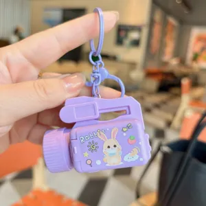 Cute purple cartoon camera keychain toy for kids, fun creative animal pendant accessory.