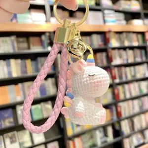 Resin unicorn keychain charm detail showing the cute braided strap and gold hardware.