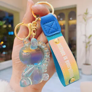 Creative resin iridescent jelly unicorn keychain with blue fabric strap and metal ring.