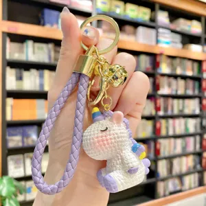 Cute resin unicorn keychain with purple braided strap and gold bell. Perfect bag charm.