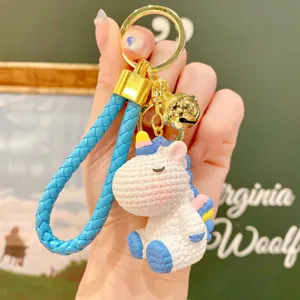 Cute resin unicorn keychain with braided strap and bell, perfect bag charm and gift.