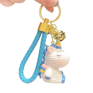 Cute unicorn keychain with blue braided strap and gold bell, perfect bag charm gift.
