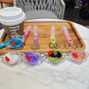 Aesthetic liquid floating heart keychain with glitter and wings, cute bag charm pendant.