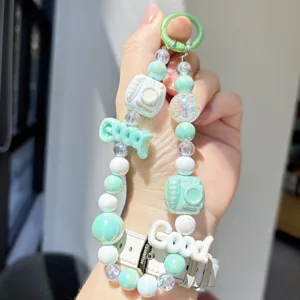 Cute cartoon macaron beaded phone chain and bag charm with cute camera and letter pendants.