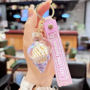 Close-up detail of the cute quicksand conch keychain with pink silicone strap and liquid.