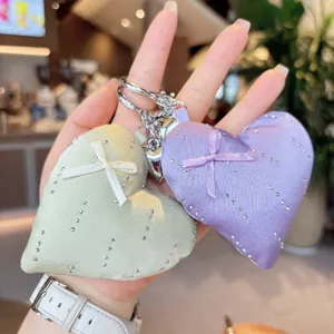 Cute heart-shaped satin keychain with rhinestones and ribbon bow, detailed view of sweet style bag charm.