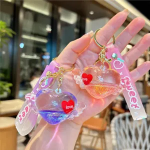 Cute liquid quicksand heart keychain with wings and sweet love details for stylish bags.
