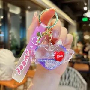 Adorable liquid quicksand heart keychain with cute wings and sweet strap for bag charm gift.