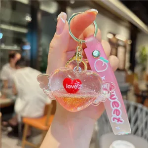 Cute liquid quicksand heart keychain with wings, stylish pink strap pendant, perfect gift.